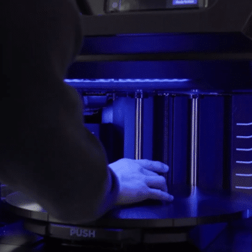Man operating 3D printer